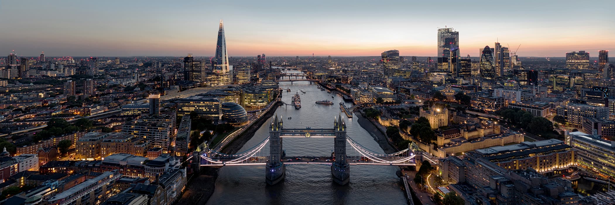 Panoramic twilight view of Tower Bridge and the London skyline.